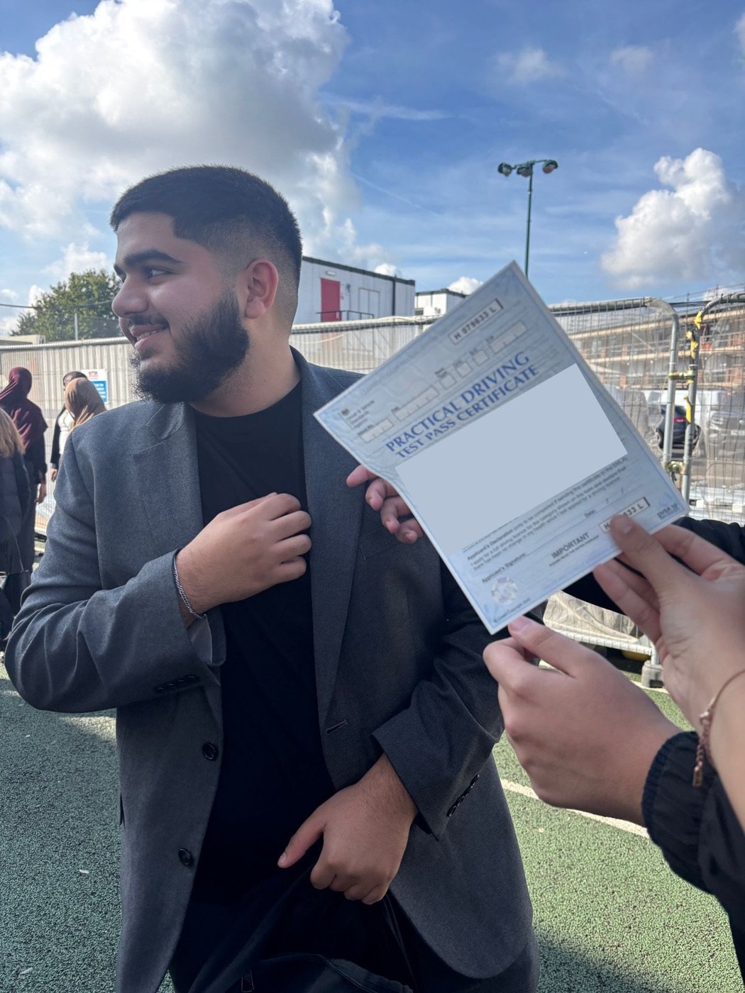 GokhanDrive student celebrating with his practical driving test pass certificate